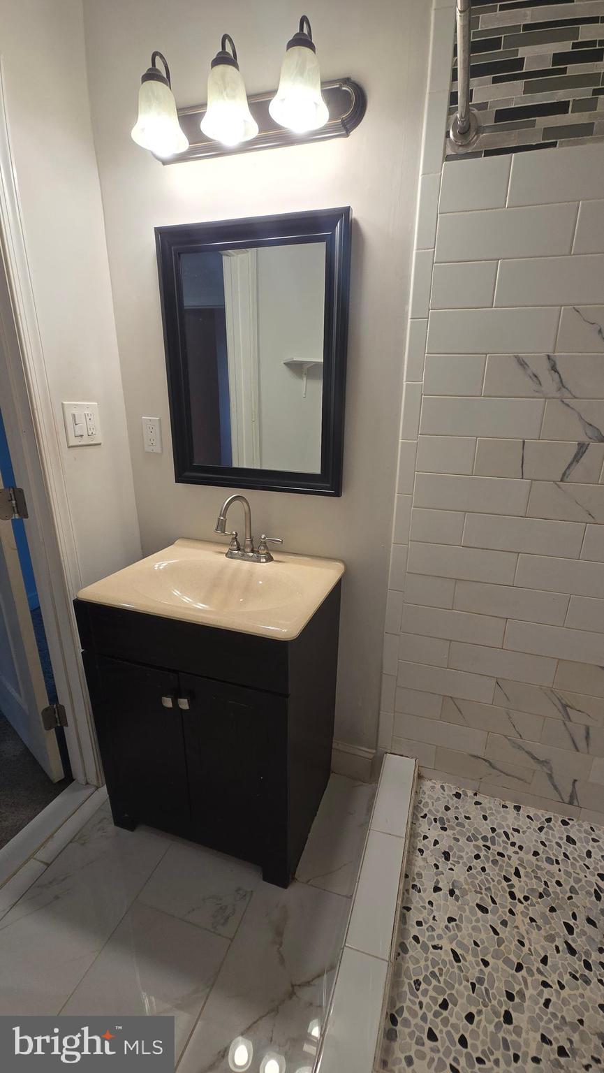 6814 Harford Road Baltimore, MD 21234 - Photo 19 of 27 a bathroom with a sink vanity and mirror