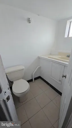 a bathroom with a toilet and a washing machine