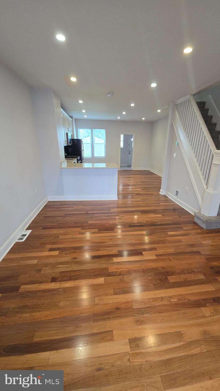 6814 Harford Road Baltimore, MD 21234 - Photo 8 of 27 a view of kitchen and empty room with wooden floor