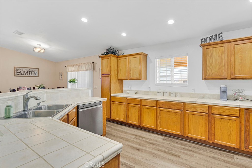 21237 S Road Apple Valley, CA 92307 - Photo 11 of 50 a large kitchen with stainless steel appliances granite countertop a sink and cabinets
