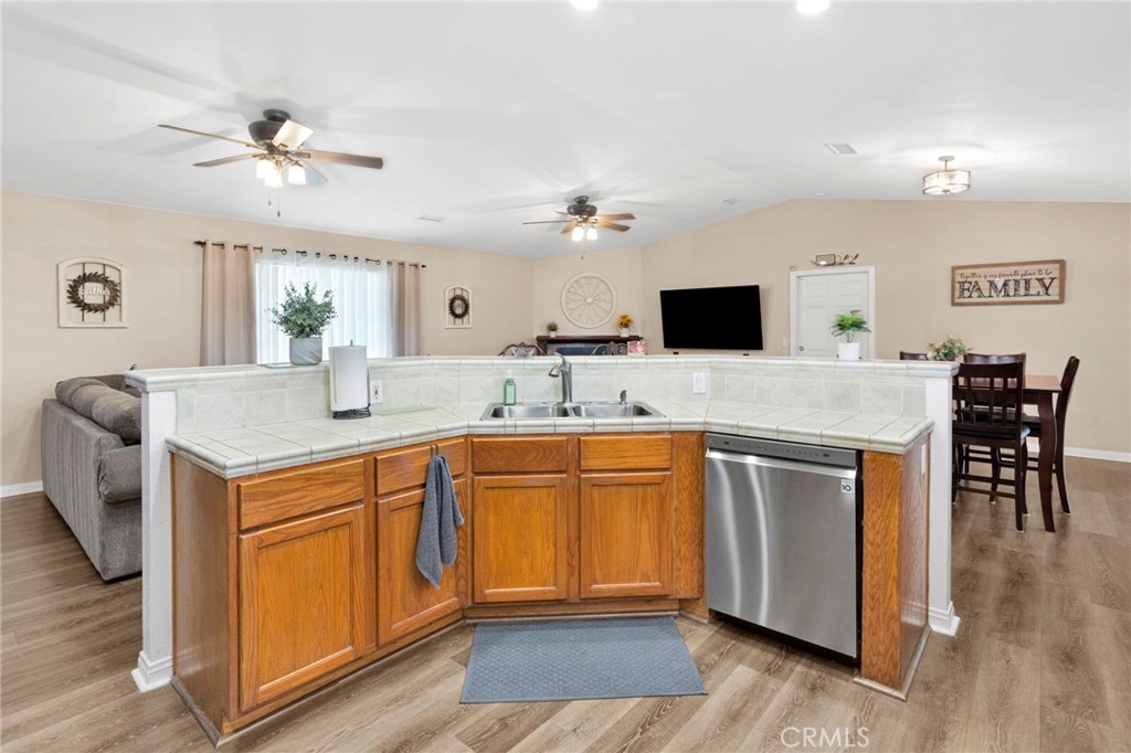 21237 S Road Apple Valley, CA 92307 - Photo 12 of 50 a kitchen with stainless steel appliances granite countertop a sink and a refrigerator