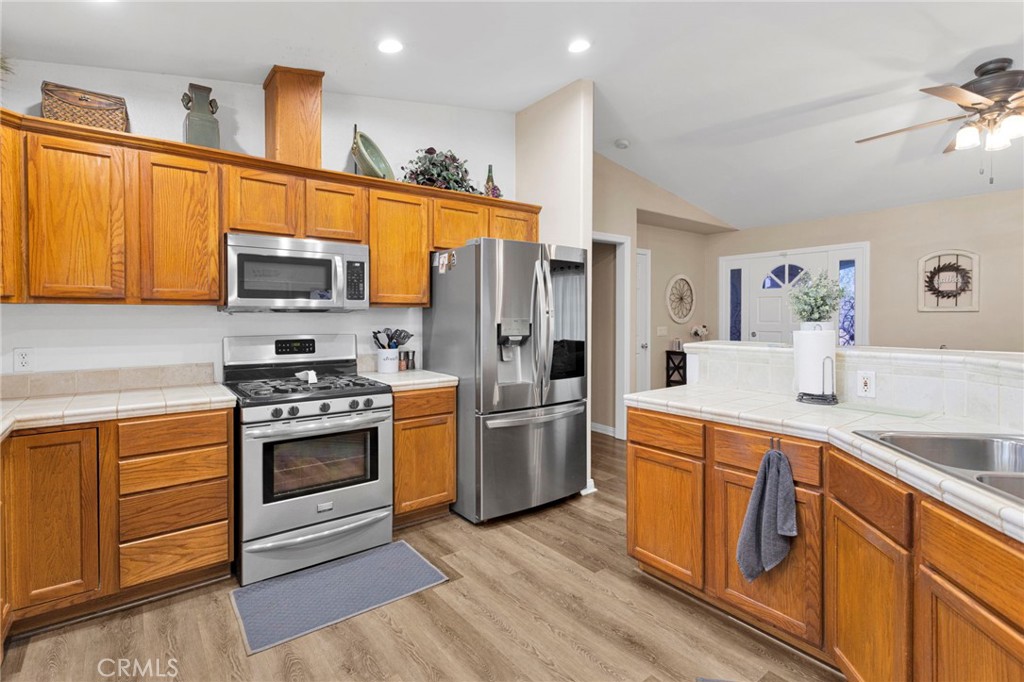 21237 S Road Apple Valley, CA 92307 - Photo 13 of 50 a kitchen with a sink stove and refrigerator