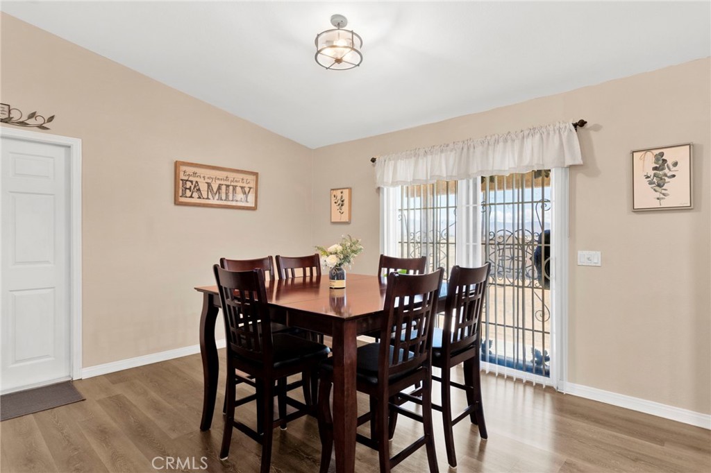 21237 S Road Apple Valley, CA 92307 - Photo 14 of 50 a view of a dining room with furniture and wooden floor
