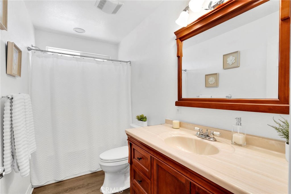 21237 S Road Apple Valley, CA 92307 - Photo 18 of 50 a bathroom with a granite countertop sink toilet and shower