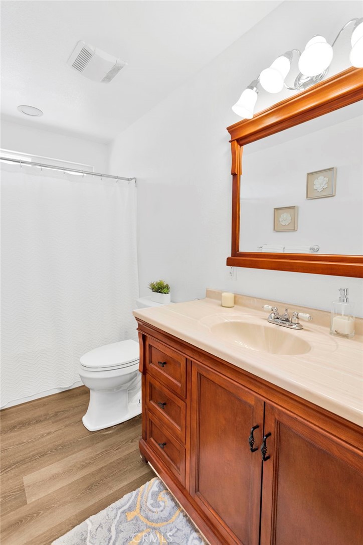 21237 S Road Apple Valley, CA 92307 - Photo 19 of 50 a bathroom with a sink a toilet and mirror