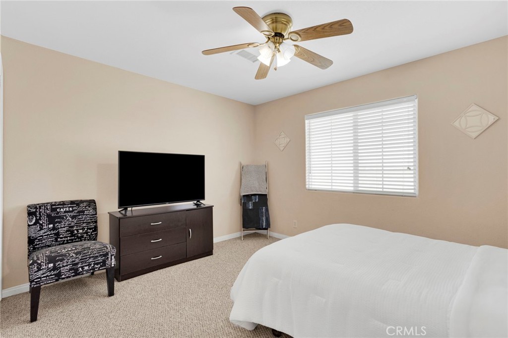 21237 S Road Apple Valley, CA 92307 - Photo 20 of 50 a bedroom with a bed and a television