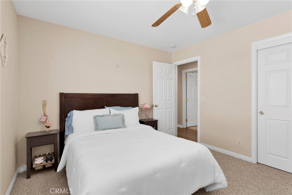 21237 S Road Apple Valley, CA 92307 - Photo 21 of 50 a bedroom with a bed and night stand