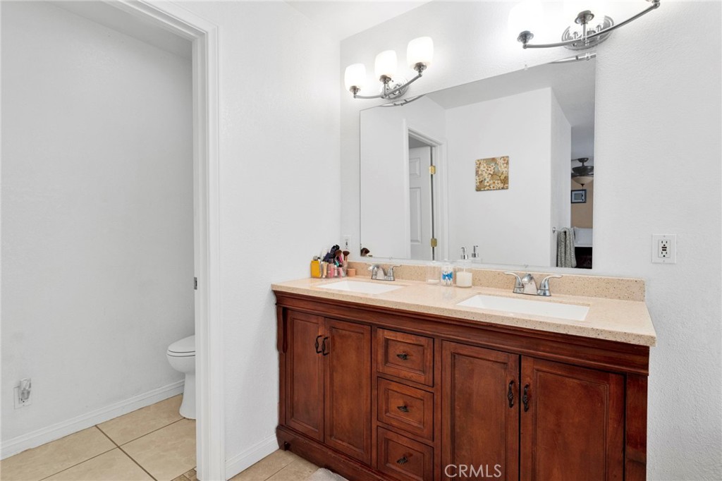 21237 S Road Apple Valley, CA 92307 - Photo 22 of 50 a bathroom with a double vanity sink and a mirror