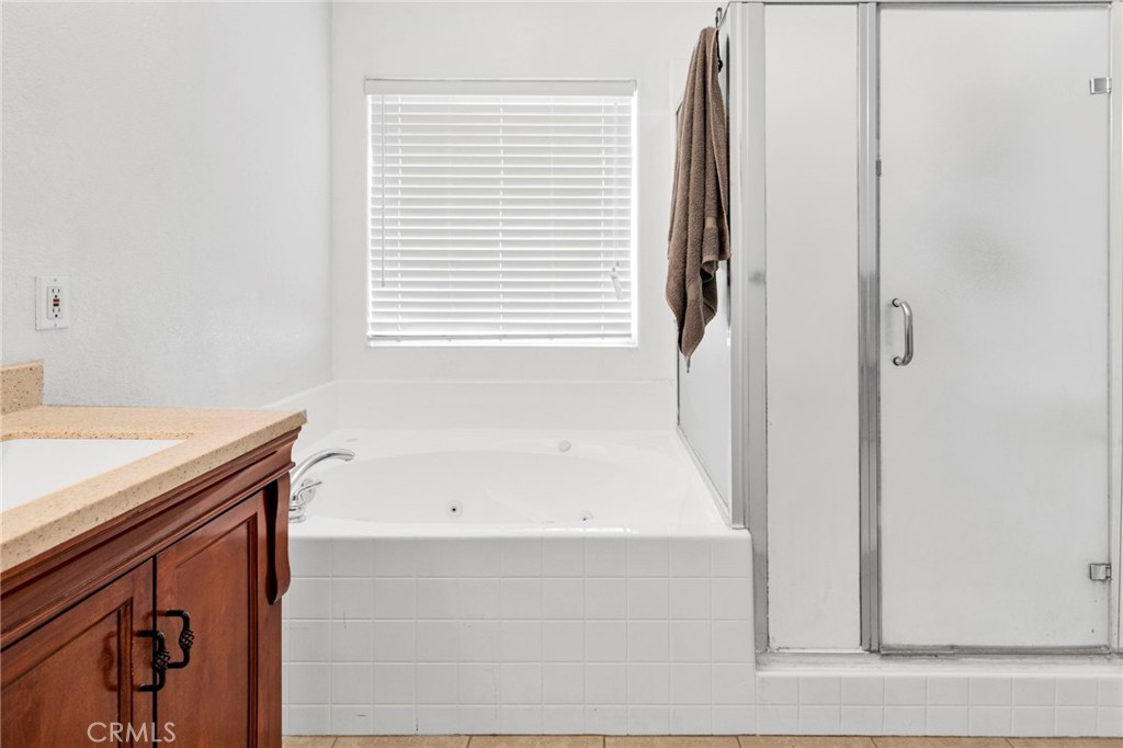 21237 S Road Apple Valley, CA 92307 - Photo 24 of 50 a bathroom with a bathtub and a shower