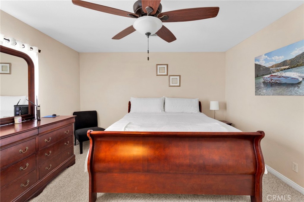 21237 S Road Apple Valley, CA 92307 - Photo 25 of 50 a bedroom with a bed and a dresser