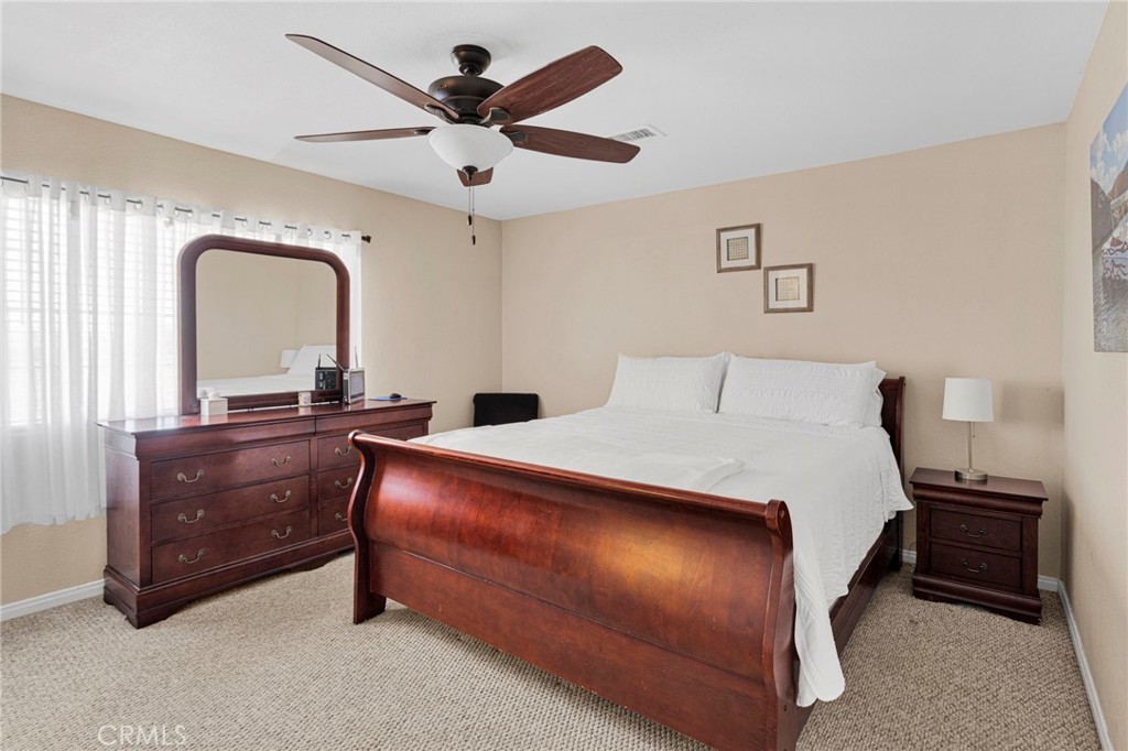 21237 S Road Apple Valley, CA 92307 - Photo 26 of 50 a bedroom with a bed and a dresser