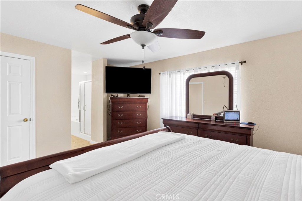 21237 S Road Apple Valley, CA 92307 - Photo 27 of 50 a bedroom with a bed and a flat screen tv