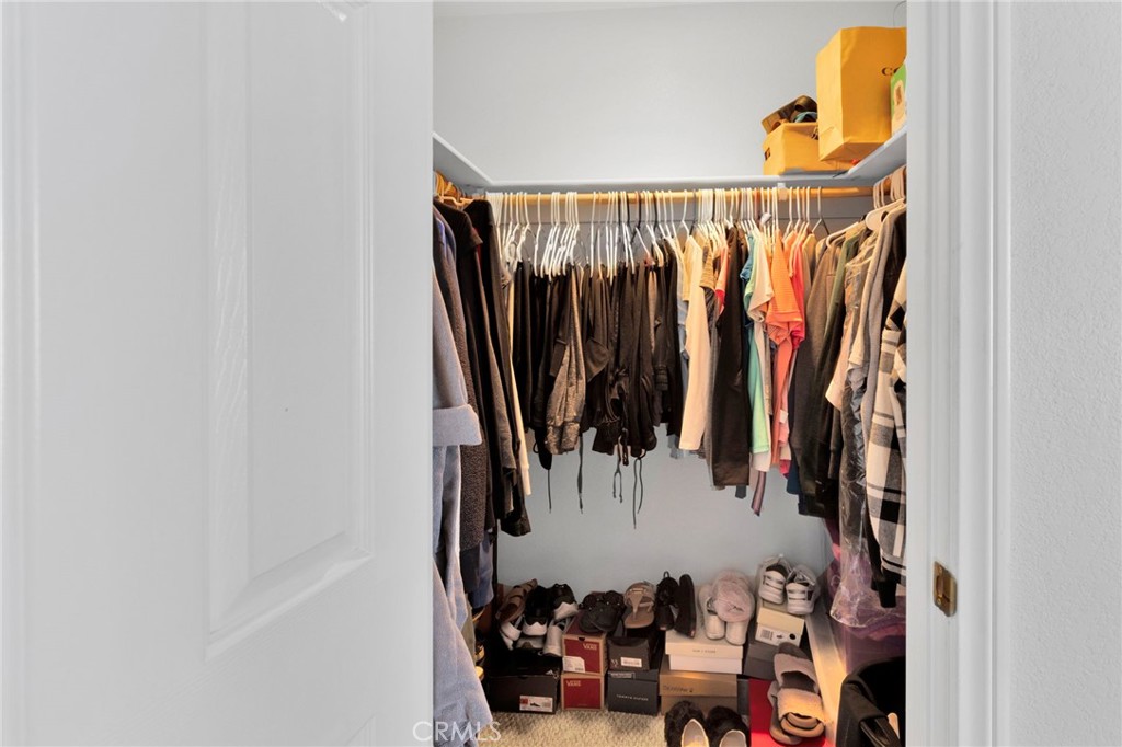 21237 S Road Apple Valley, CA 92307 - Photo 28 of 50 a view of walk in closet with clothes and shoes