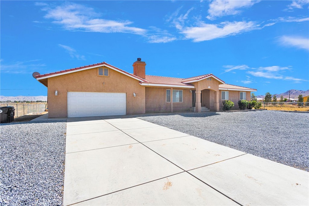 21237 S Road Apple Valley, CA 92307 - Photo 3 of 50 a front view of a house with a yard