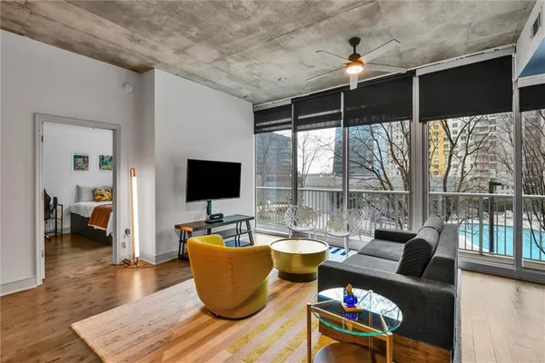 a living room with furniture and a flat screen tv