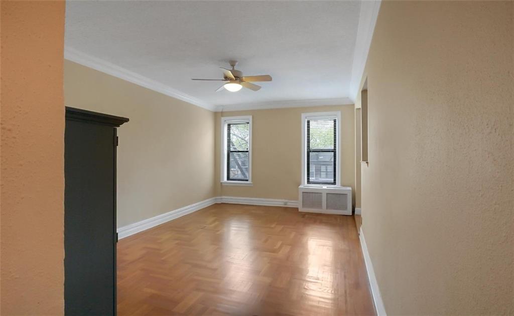 7101 Colonial Road, Unit R2B Brooklyn, NY 11209 - Photo 2 of 10 a view of empty room with wooden floor and fan
