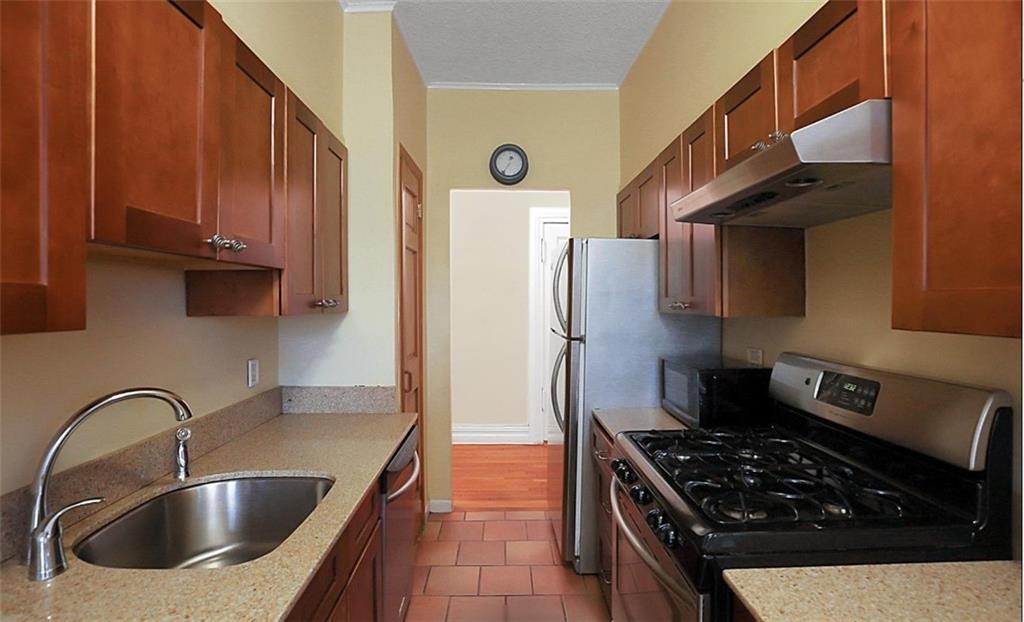 7101 Colonial Road, Unit R2B Brooklyn, NY 11209 - Photo 4 of 10 a kitchen with stainless steel appliances granite countertop a sink stove and refrigerator