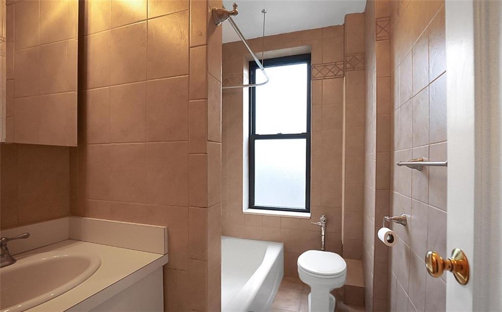 7101 Colonial Road, Unit R2B Brooklyn, NY 11209 - Photo 8 of 10 a bathroom with a sink toilet and shower