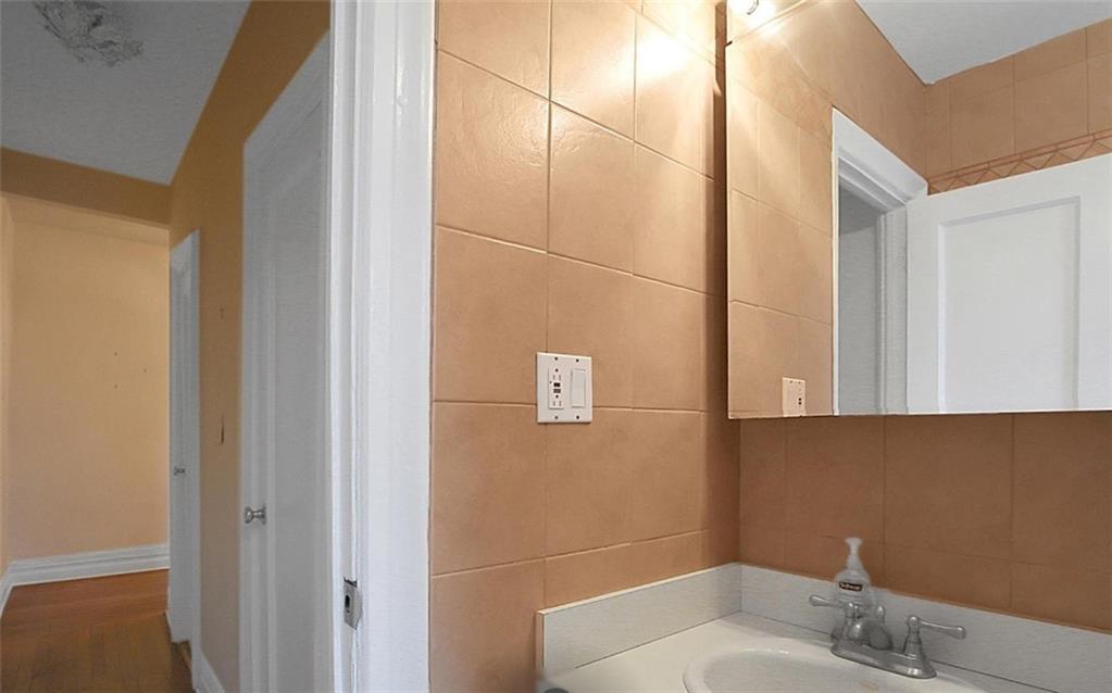 7101 Colonial Road, Unit R2B Brooklyn, NY 11209 - Photo 9 of 10 a bathroom with a sink and mirror