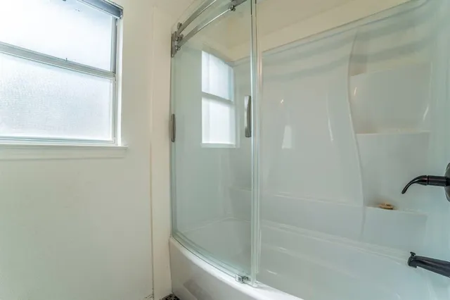 a bathroom with a granite countertop sink toilet and a mirror