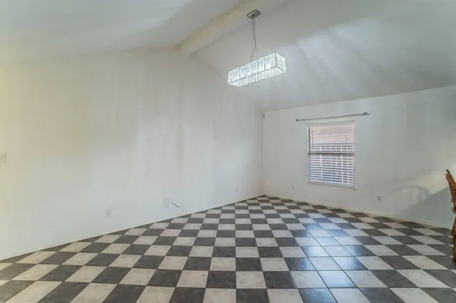 a view of a big room with windows and chandelier
