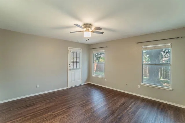 a view of a hallway with wooden floor and a chandelier