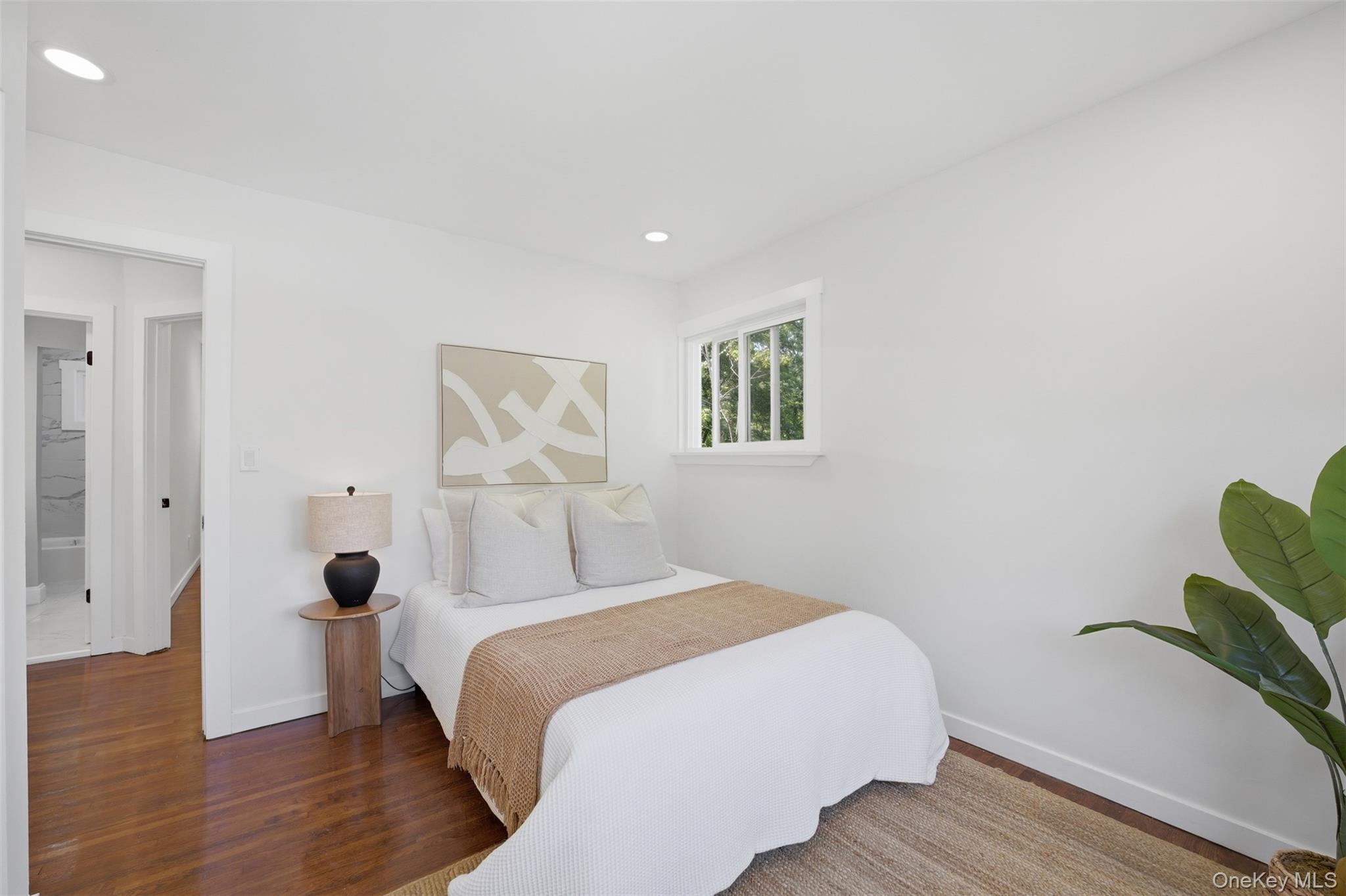 24 Fuller Road Ossining, NY 10562 - Photo 17 of 48 a bedroom with a bed and a painting on the wall