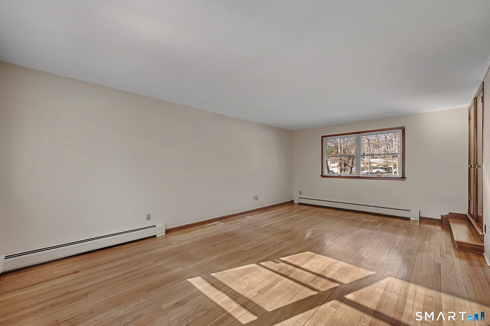 67 Hillside Lane Monroe, CT 06468 - Photo 16 of 40 You will be greeted by hardwood floors and large windows that allows an abundance of natural light to flood the space, this creates a warm and inviting ambiance.