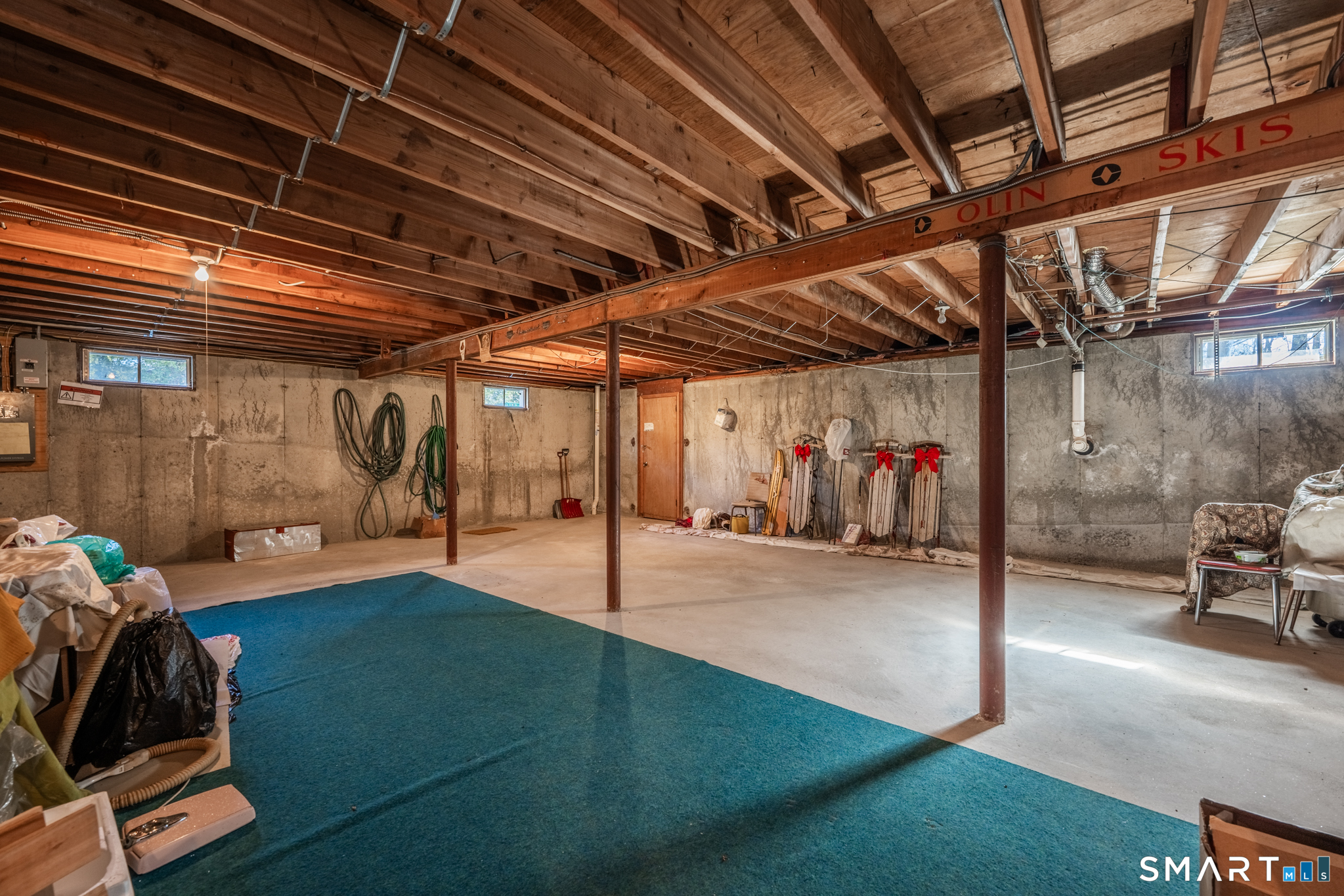 67 Hillside Lane Monroe, CT 06468 - Photo 30 of 40 The large unfinished basement offers endless possibilities, characterized by its generous dimensions and high ceilings, making it an ideal canvas for transformation.
