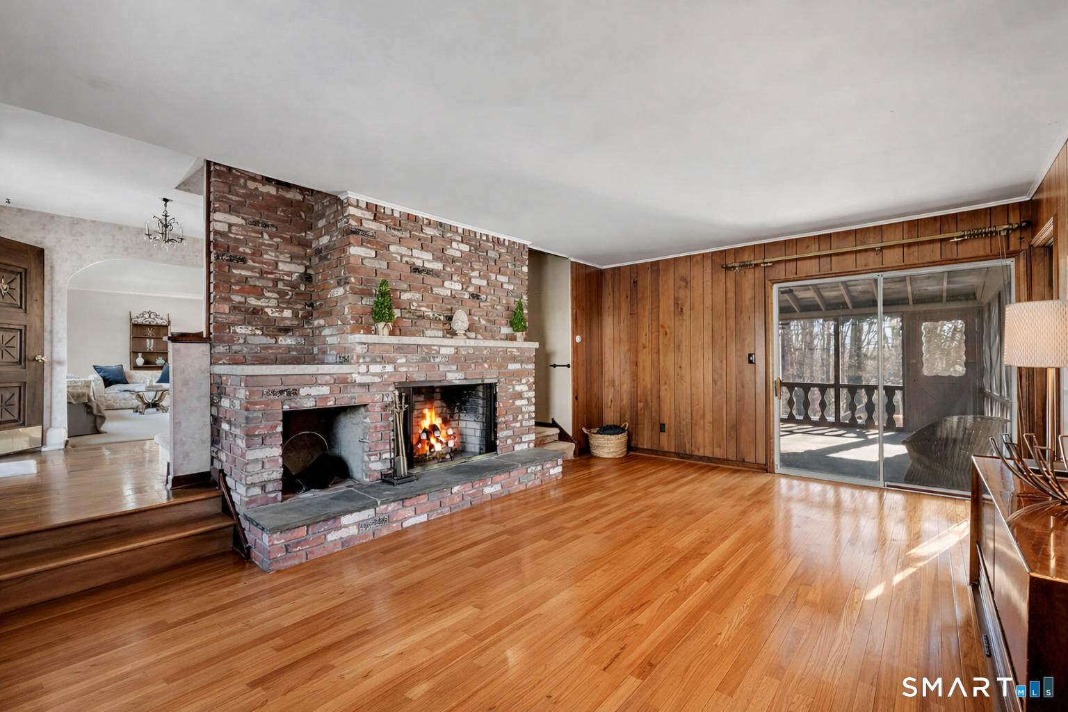 67 Hillside Lane Monroe, CT 06468 - Photo 9 of 40 The focal point of the room, the fireplace, makes it an ideal spot for family gatherings or quiet evenings. The sliding glass doors take you to the amazing screened-in porch.
