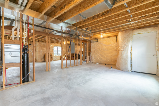 1228 North Providence Way Tooele, UT 84074 - Photo 23 of 28 Unfinished basement featuring exposed wood joists, concrete flooring, and partial framing