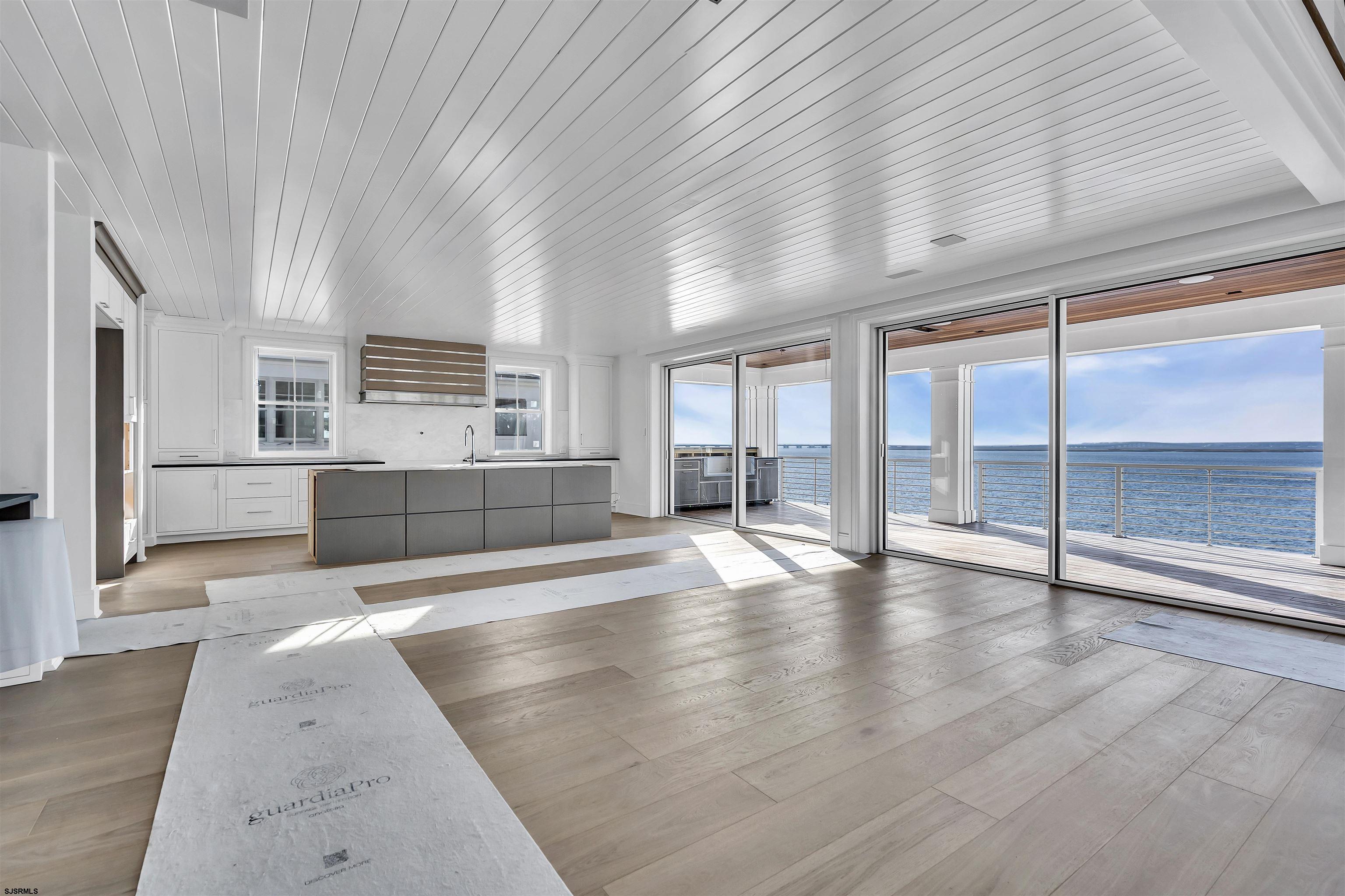 176-80 Bay Road Ocean City, NJ 08226 - Photo 11 of 58 an empty room with wooden floor and windows