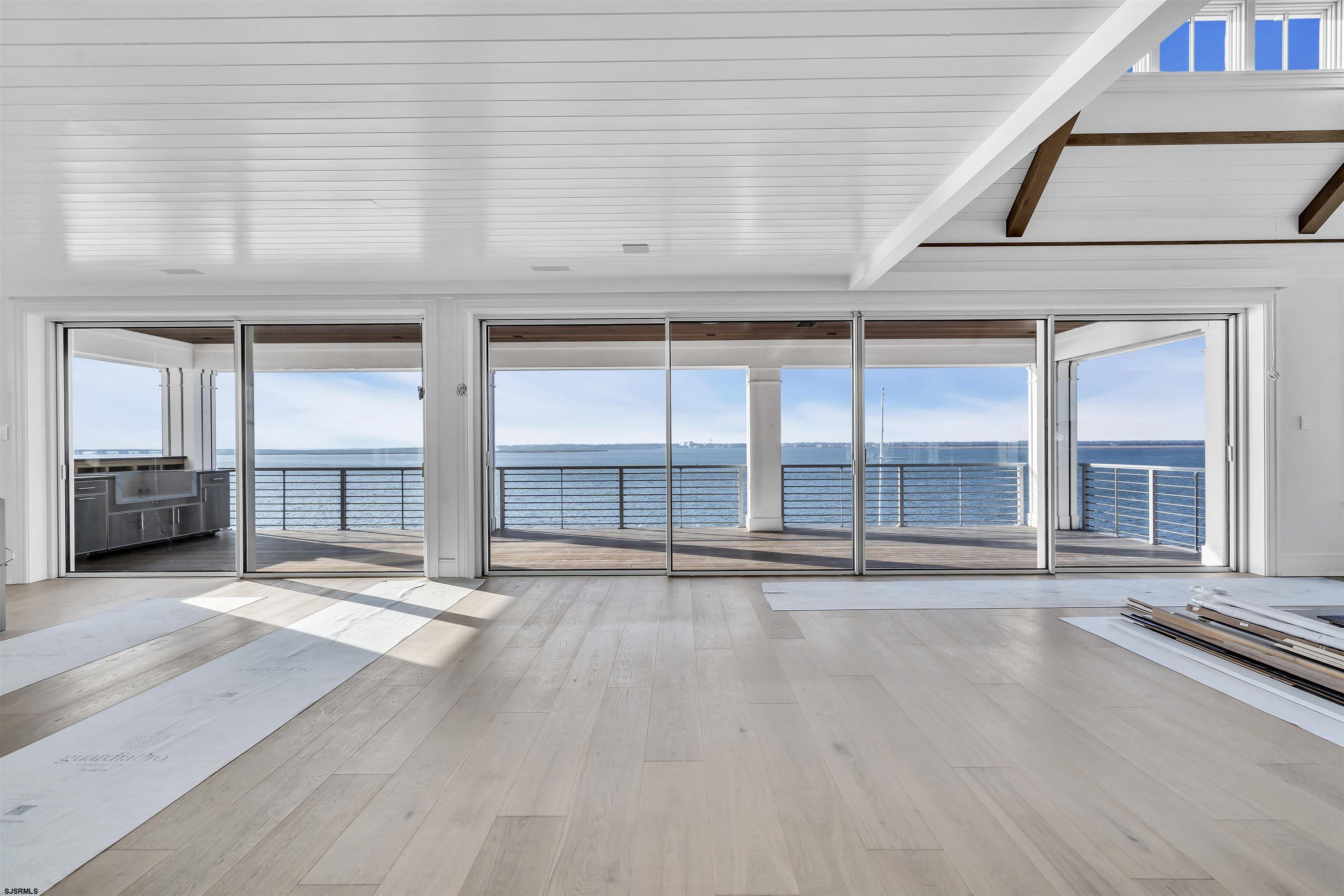 176-80 Bay Road Ocean City, NJ 08226 - Photo 12 of 58 an empty room with wooden floor and windows