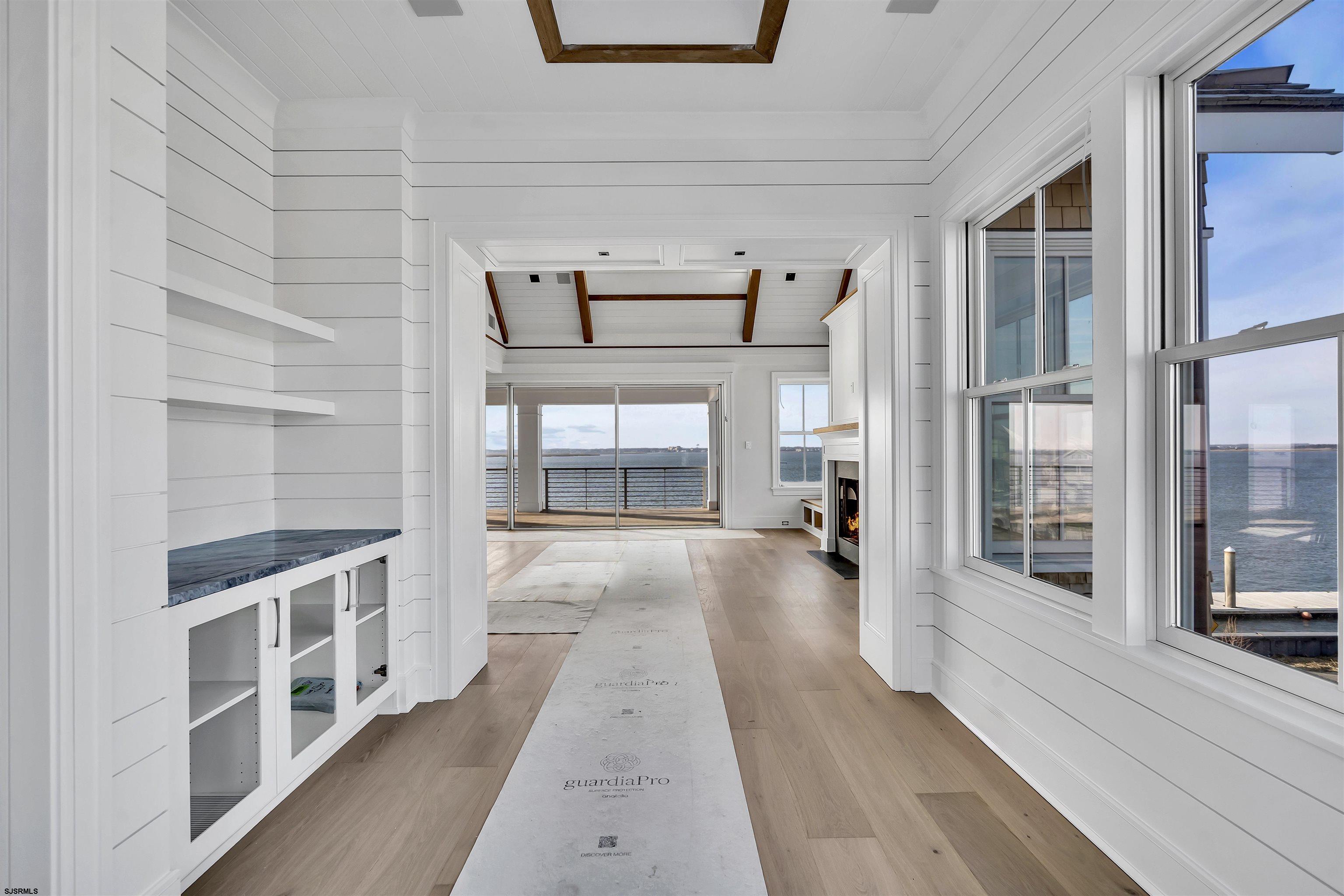 176-80 Bay Road Ocean City, NJ 08226 - Photo 18 of 58 a view of a hallway with wooden floor fireplace and windows