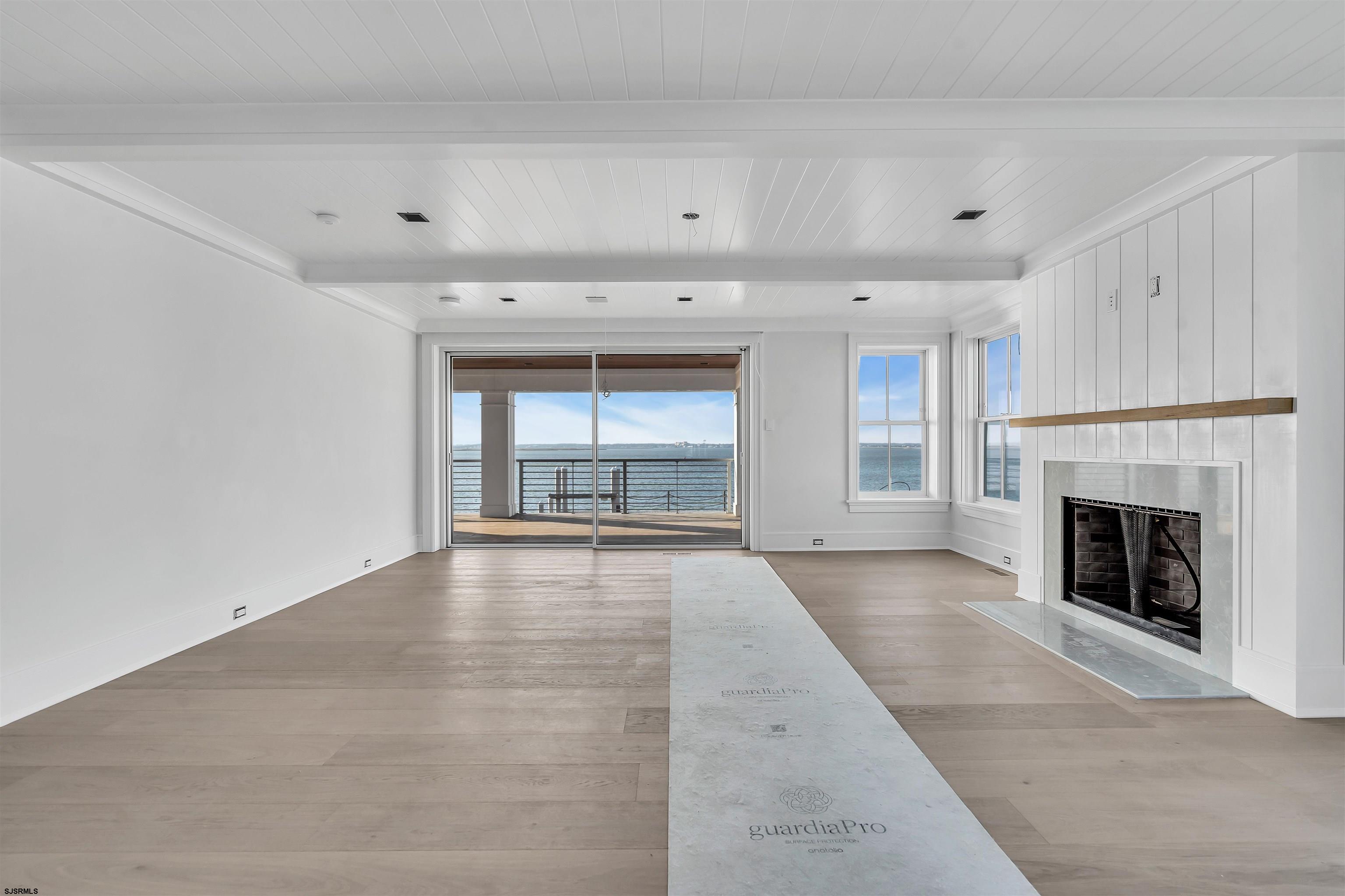176-80 Bay Road Ocean City, NJ 08226 - Photo 20 of 58 a view of an empty room with a fireplace and a window