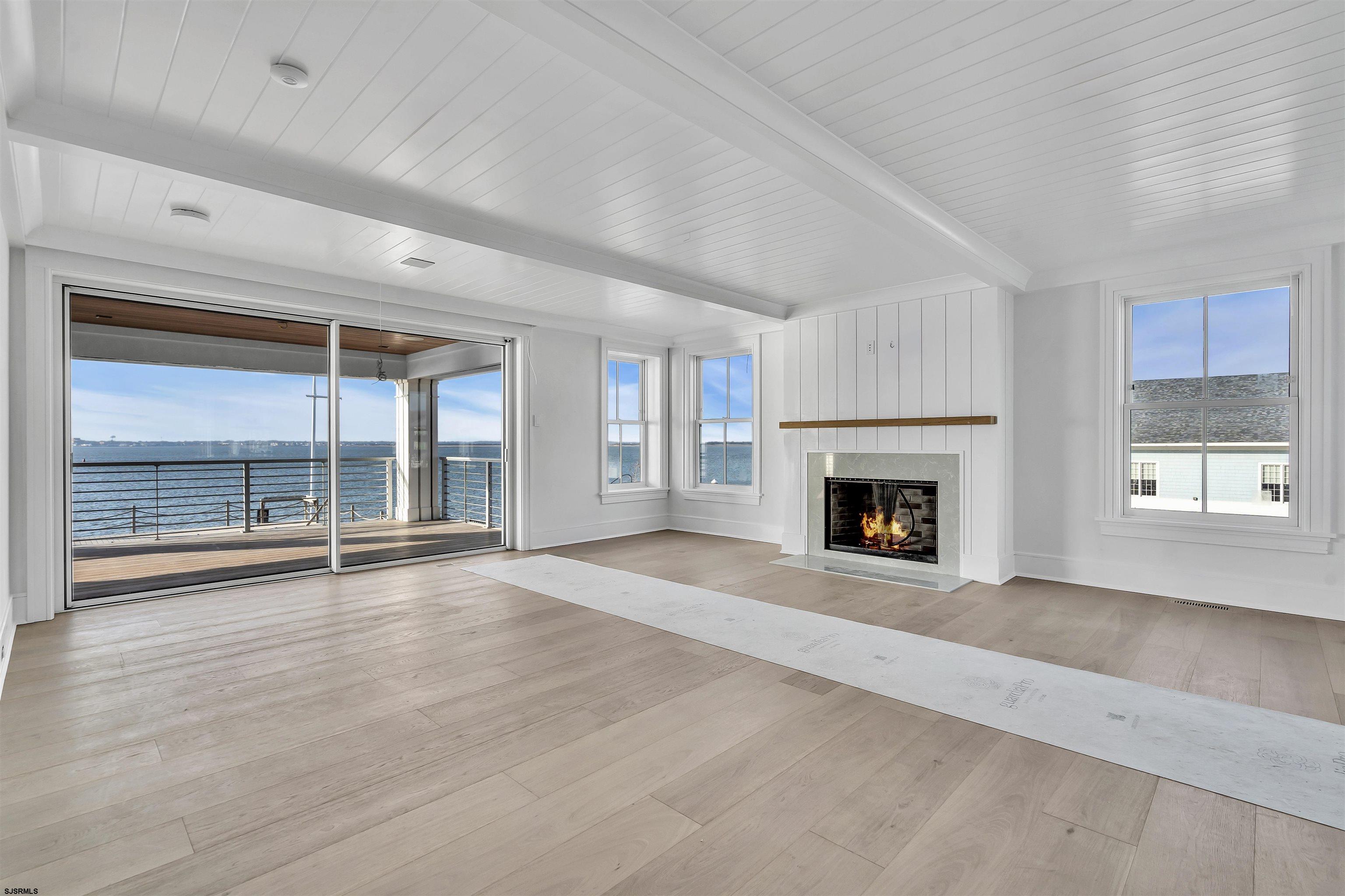 176-80 Bay Road Ocean City, NJ 08226 - Photo 21 of 58 a view of an empty room with a fireplace and a window