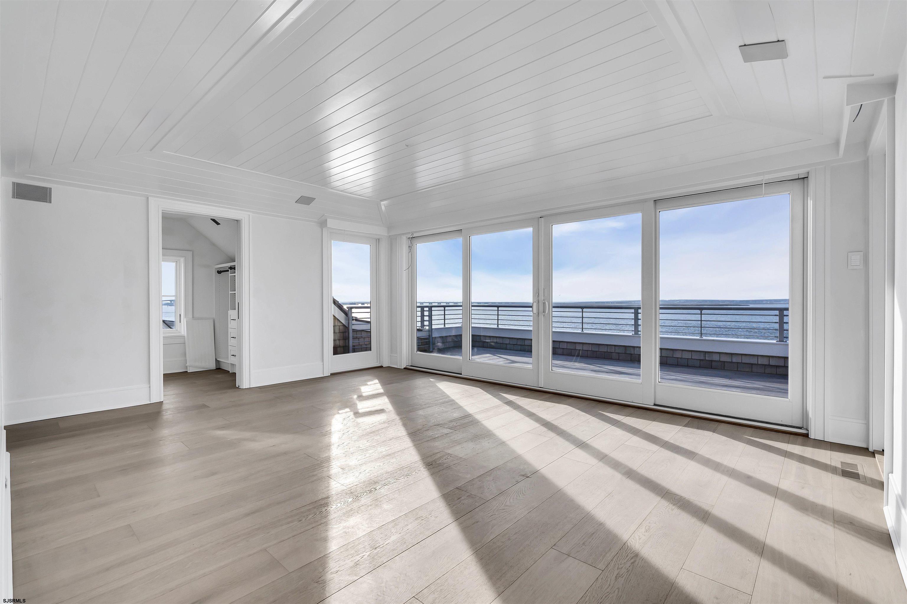 176-80 Bay Road Ocean City, NJ 08226 - Photo 25 of 58 a view of an empty room with wooden floor and a window