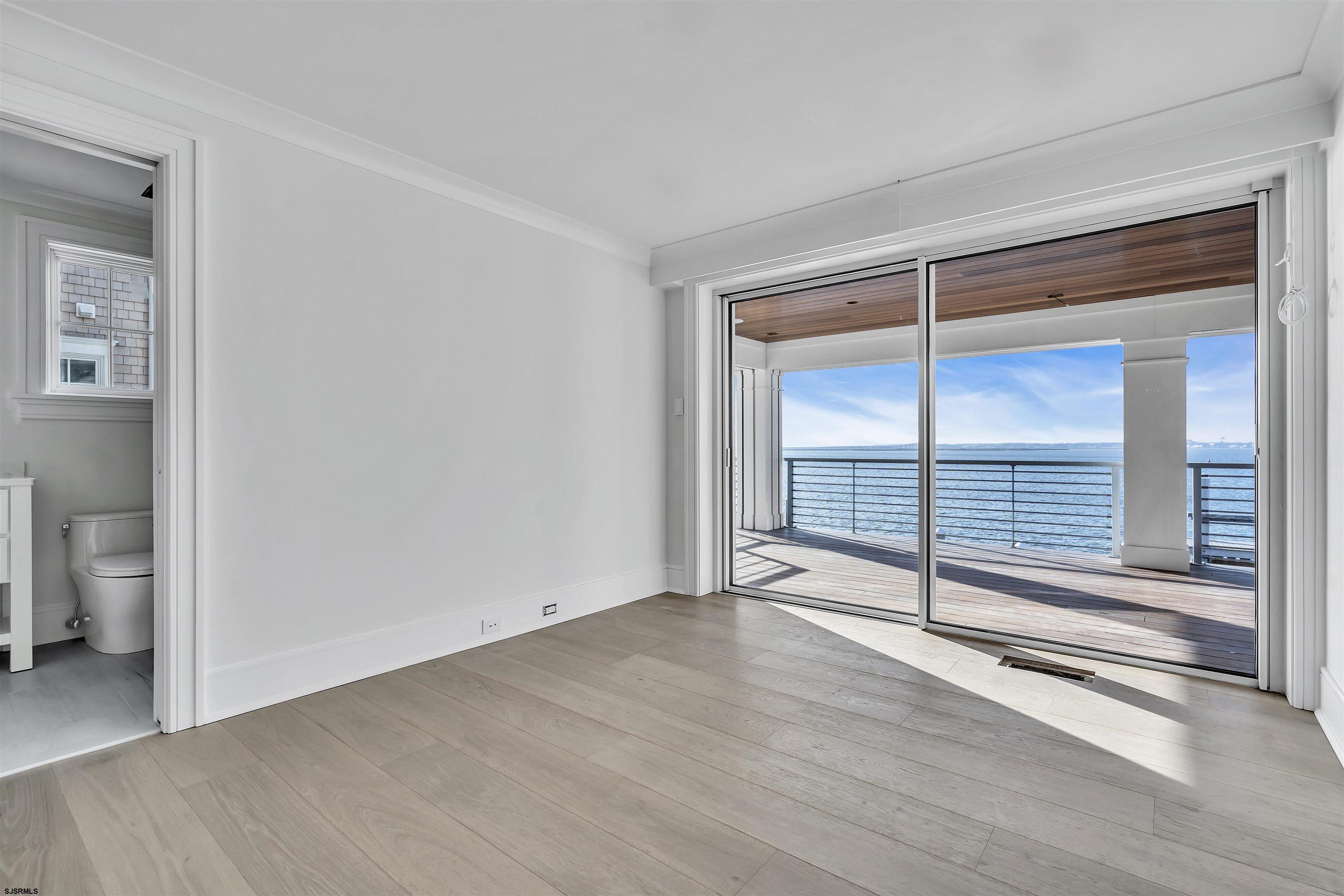176-80 Bay Road Ocean City, NJ 08226 - Photo 30 of 58 an empty room with wooden floor and windows