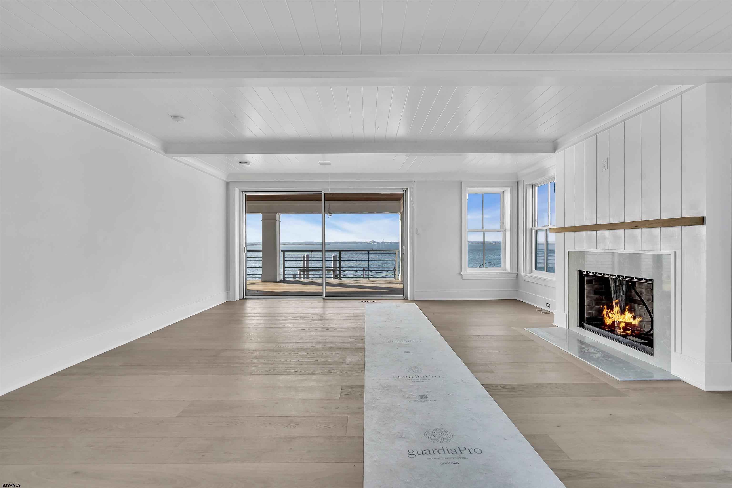 176-80 Bay Road Ocean City, NJ 08226 - Photo 7 of 58 a view of an empty room with a fireplace and a window