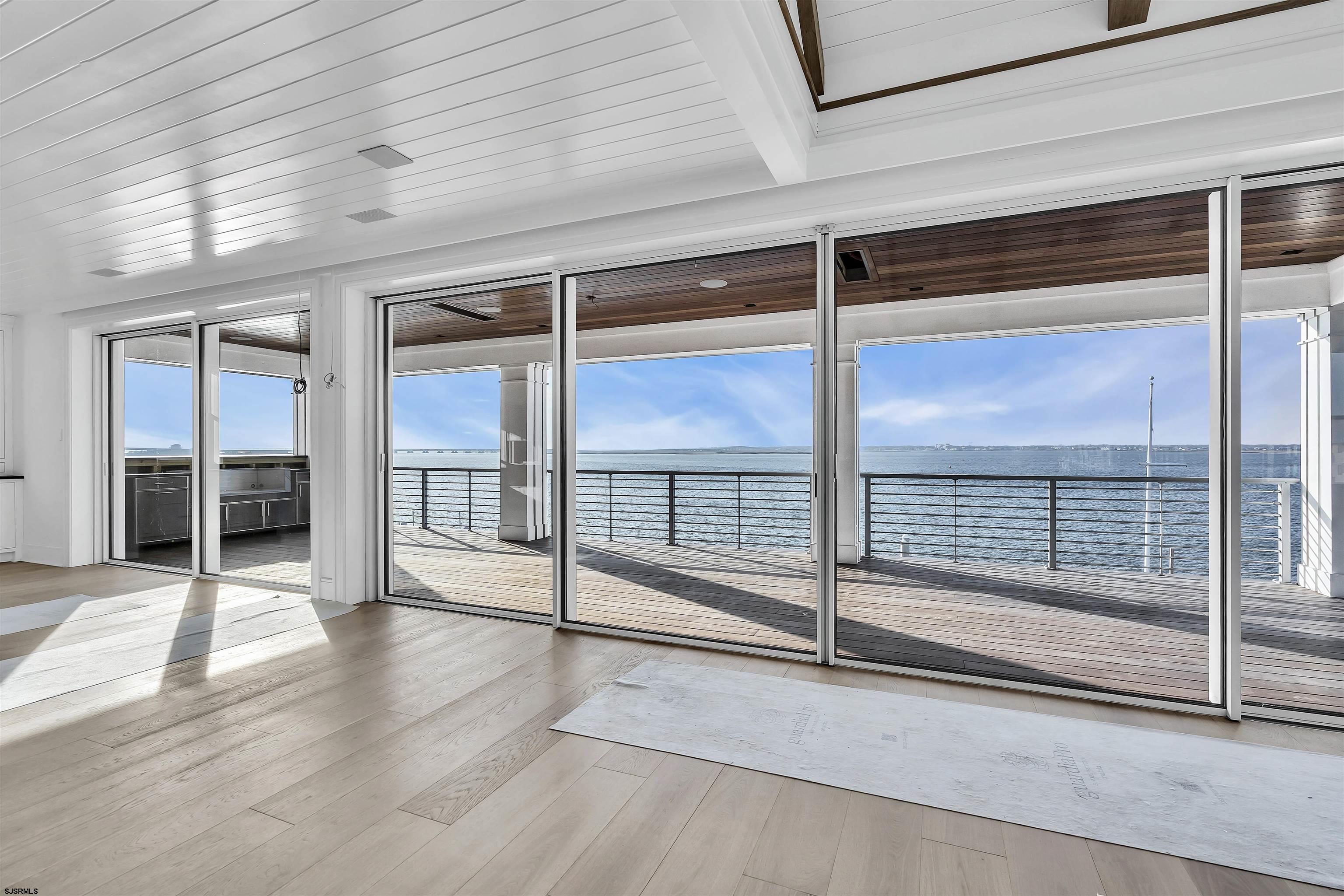 176-80 Bay Road Ocean City, NJ 08226 - Photo 9 of 58 an empty room with wooden floor and windows