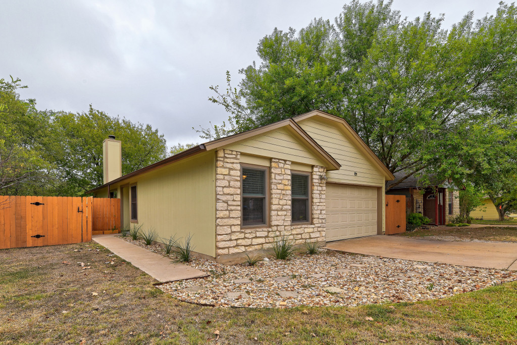 6002 Baton Rouge Drive Austin, TX 78727 - Photo 2 of 20 Single-story residence featuring light yellow siding and a stone-veneer facade