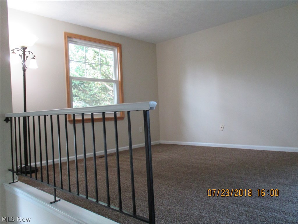 6302 Berwick Road Madison, OH 44057 - Photo 11 of 20 Living room on main floor with access to lower level.