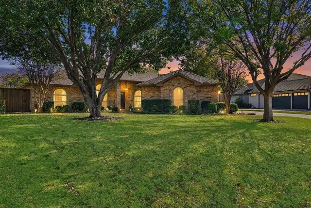 a front view of house with yard and green space