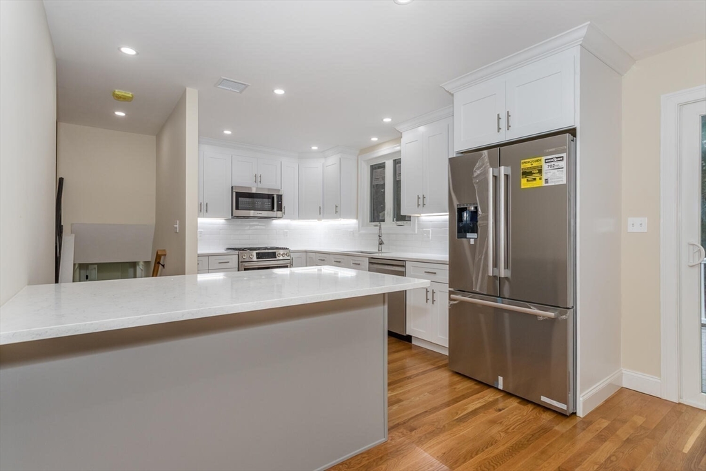 71 Morton Street Canton, MA 02021 - Photo 12 of 39 a kitchen with a refrigerator and a sink
