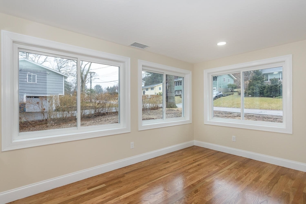 71 Morton Street Canton, MA 02021 - Photo 14 of 39 a view of an empty room with wooden floor and a window
