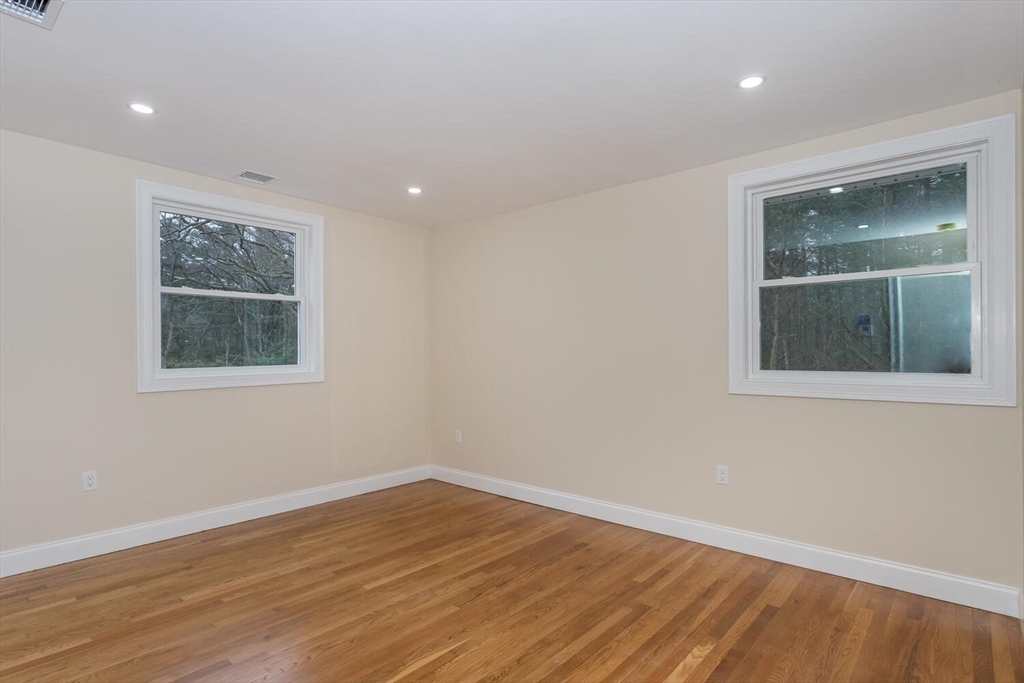 71 Morton Street Canton, MA 02021 - Photo 17 of 39 a view of an empty room with wooden floor and a window