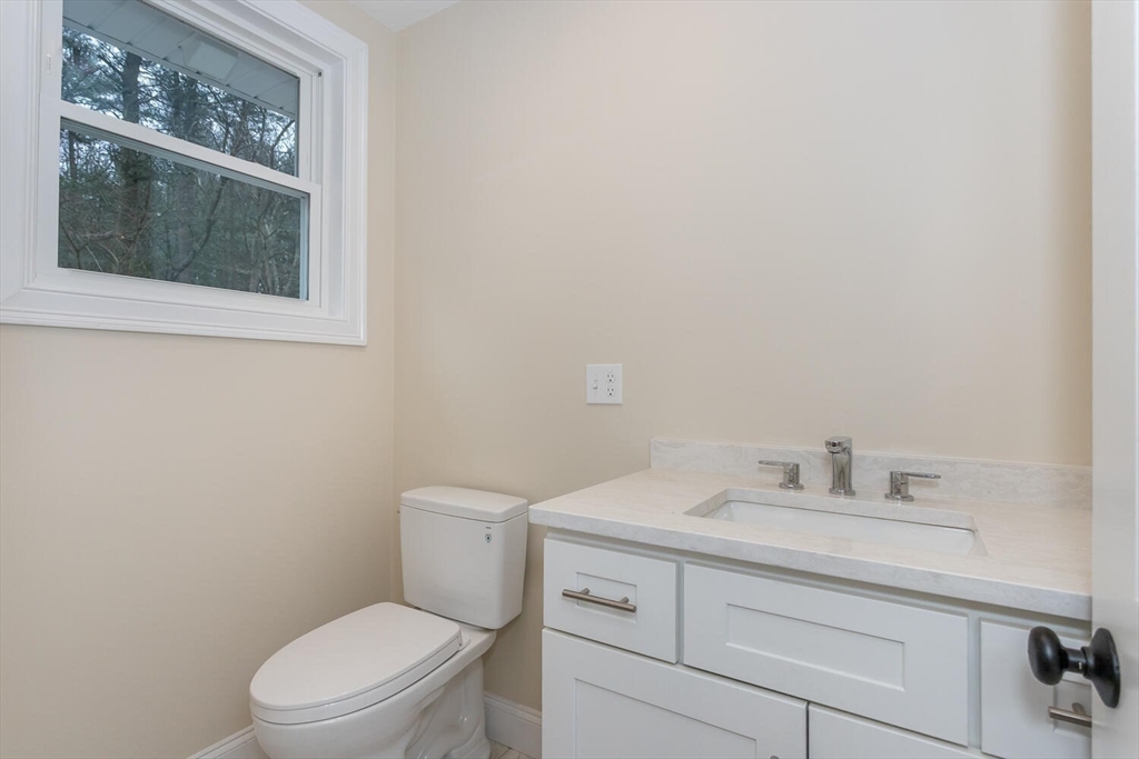 71 Morton Street Canton, MA 02021 - Photo 20 of 39 a bathroom with a toilet sink vanity and mirror