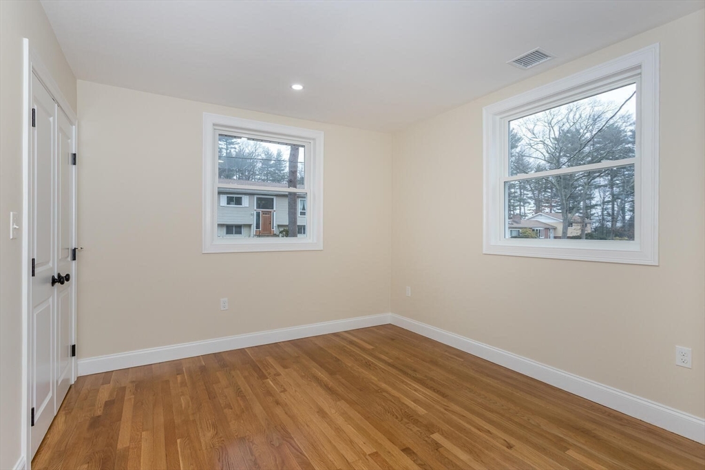 71 Morton Street Canton, MA 02021 - Photo 22 of 39 a view of an empty room with wooden floor and a window