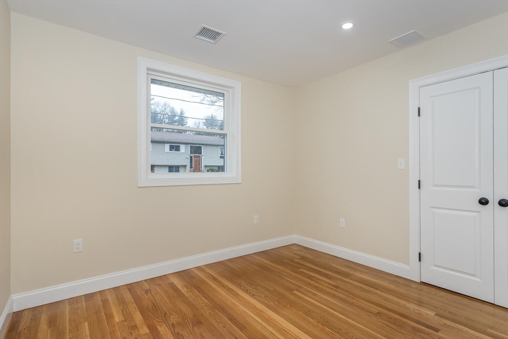71 Morton Street Canton, MA 02021 - Photo 23 of 39 an empty room with wooden floor and windows