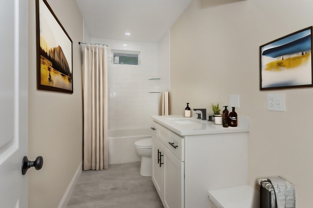 71 Morton Street Canton, MA 02021 - Photo 25 of 39 a bathroom with a toilet sink and mirror